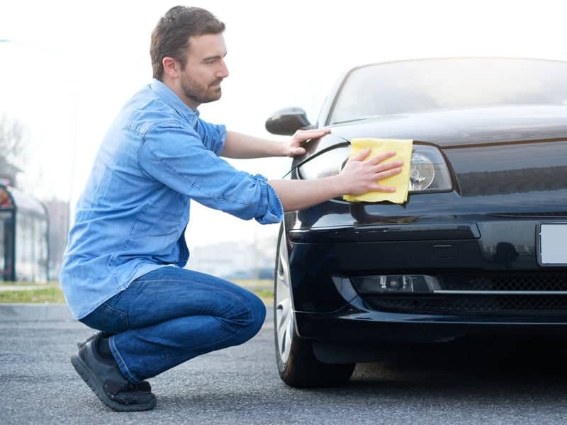 man taking car and cleaning his car