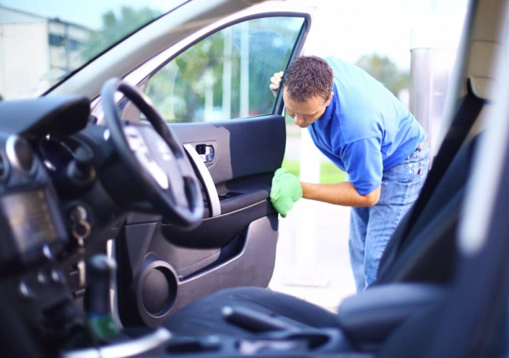 Man cleaning the interior of his car