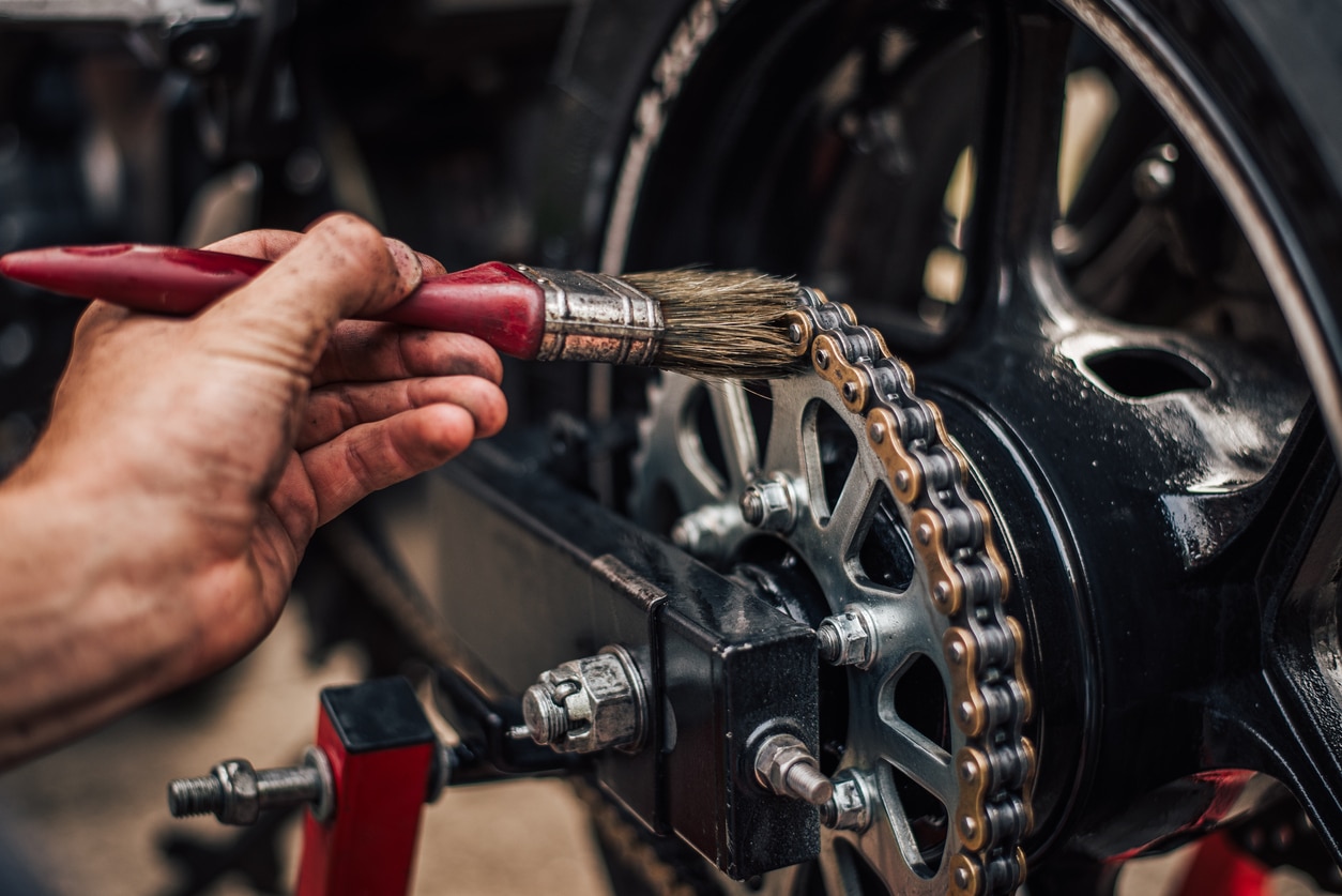 oiling the chain on motorcycle