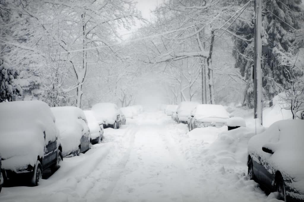Streets covered with snow, cars getting stuck in the street